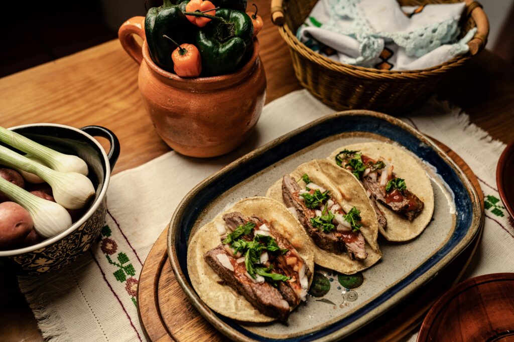 pexels-photo-7613563-7613563 Delicious Mexican tacos served with fresh ingredients, highlighting vibrant flavors and traditional presentation.